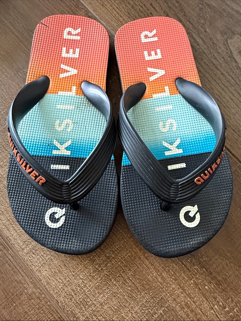 Quiksilver Men’s Black Flip Flops with Orange-Blue Gradient Footbed